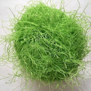 May include: A large ball of bright green shredded paper, also known as crinkle cut paper, used for gift wrapping and packaging.
