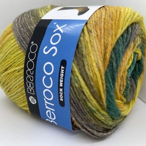 May include: A skein of Berroco Sox yarn in a multi-colored pattern of yellow, green, and gray. The label reads "Berroco Sox" and "Sock Weight".