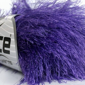 May include: Purple fuzzy yarn with a label that says "Ice Yarns" on it.