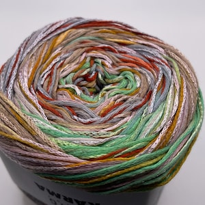 May include: A ball of yarn with a multi-colored pattern of green, orange, brown, and gray. The yarn is wound into a tight ball.