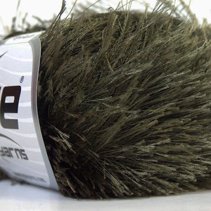 May include: A skein of dark green fuzzy yarn with the text "Ice Yarns" on the label.