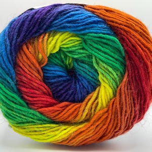 May include: A vibrant ball of yarn in a rainbow of colors, including red, orange, yellow, green, blue, and purple. The yarn is tightly wound, showcasing the gradient of colors. Ideal for knitting and crochet projects.