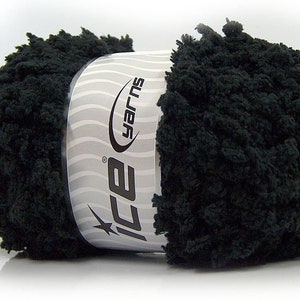 May include: A ball of black yarn with a textured, looped appearance. The yarn is wrapped with a label that reads "Ice Yarns" in a stylized font. The label has a silver and white wavy design.