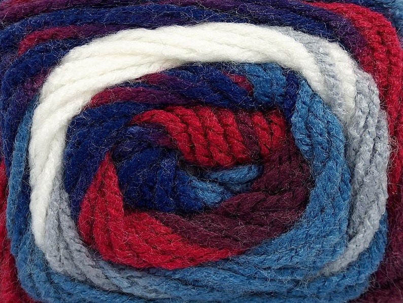 May include: A skein of yarn with a multi-colored pattern of white, gray, blue, red, and purple.