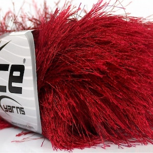 May include: A skein of deep red fuzzy yarn with a white label that says "Ice Yarns" with a star logo.