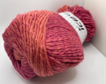 May include: A ball of pink and orange yarn with a white label that says "BC Garn" on it.