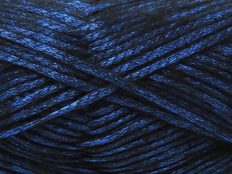 May include: A skein of dark blue metallic yarn with a subtle shimmer.