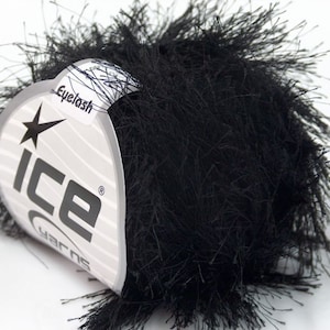 May include: A skein of black eyelash yarn with a white label that says "Ice Yarns" and "Eyelash".