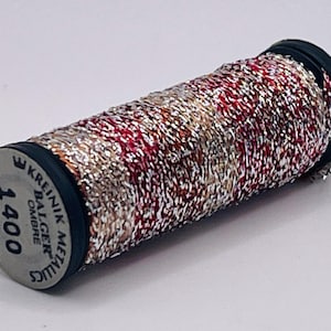 May include: A spool of Kreinik Balger metallic ombre thread, color 1400, featuring a blend of silver, red, and copper metallic fibers. The spool end displays the brand name, color number 1400, and the length of 15M (16-1/2 YDS).