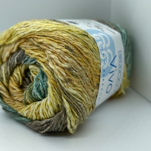 May include: A skein of yarn in shades of green, brown, and yellow. The yarn is labeled "VINO" and "BEACHY" on the label.