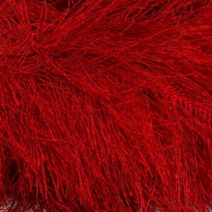 May include: Red fluffy yarn with a long, thin texture. The yarn is soft and has a fuzzy appearance.