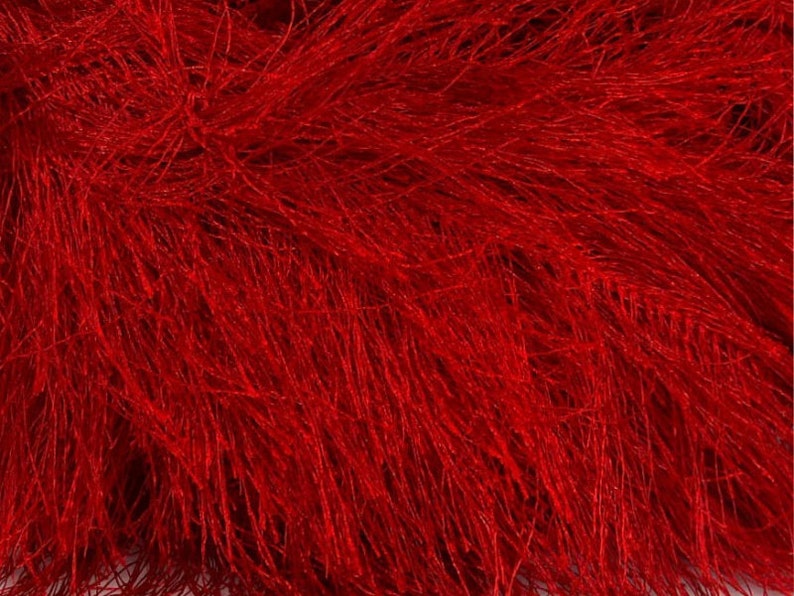 May include: Red fluffy yarn with a long, thin texture. The yarn is soft and has a fuzzy appearance.