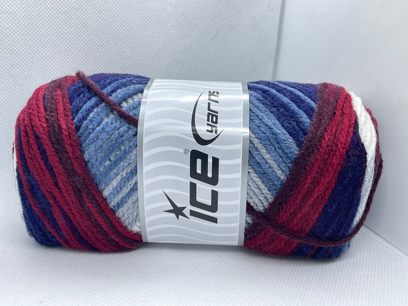 May include: A skein of yarn in a multi-colored striped pattern of red, blue, white, and gray. The yarn is labeled "Ice Yarns".