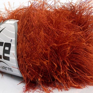May include: A skein of orange fuzzy yarn with the label "Ice Yarns" on it.
