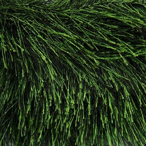 May include: A close-up of a green, fluffy garland made of thin, wispy strands. The garland is perfect for adding a touch of greenery to any space.