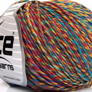 May include: A ball of Ice Yarns Lorena Colorful yarn featuring a variegated blend of bright orange, turquoise, magenta, and yellow fibers. A silver paper label is wrapped around the side, displaying the brand name ICE Yarns and a star logo.