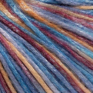 May include: A multi-colored yarn featuring a blend of vibrant blue, deep burgundy, and warm golden-tan strands. The fibers have a subtle sheen and a slightly fuzzy texture, arranged in parallel diagonal lines that create a rich, variegated appearance.