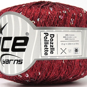 May include: A skein of red yarn with silver sequins, labeled "Dazzlle Paillette" and "Ice Yarns". The yarn is 20% Paillette, 40% Metallic Lurex, and 35% Polyester. It weighs 25 grams and is 200 meters long.