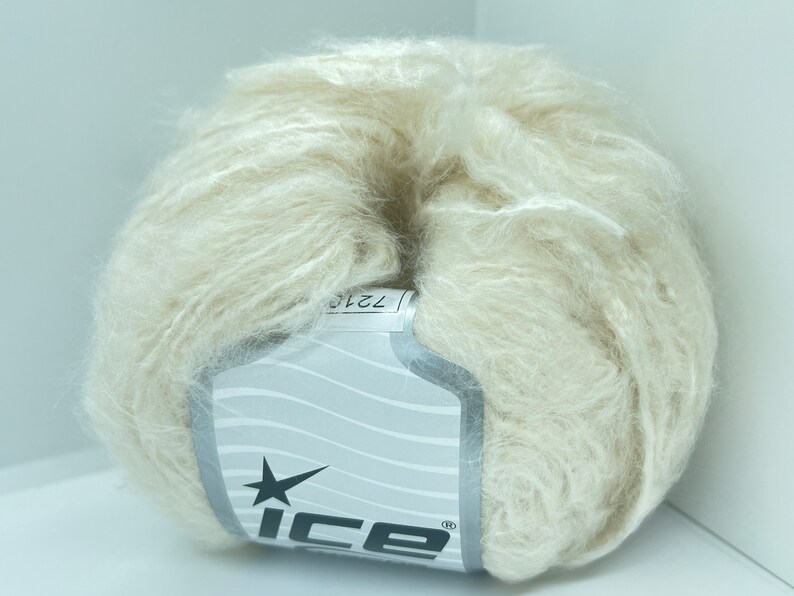 May include: A ball of off-white yarn with a label that says "ICE" and has a star logo.