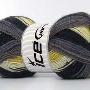 May include: A skein of yarn in a multi-colored pattern of black, gray, cream, and yellow. The yarn is wrapped around a white label with the text "ICE yarn" in black.