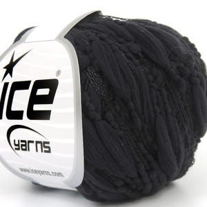 May include: A ball of black yarn with a white label featuring the text "ice yarns" and a star logo. The yarn appears to be thick and textured, suitable for knitting or crocheting projects.