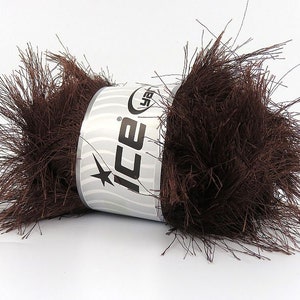 May include: A brown skein of fuzzy yarn with the brand name "ICE" printed on the label.