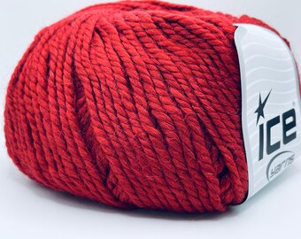 May include: A ball of vibrant red yarn, tightly wound and textured. The yarn has a thick, chunky appearance, suggesting it's suitable for knitting or crocheting projects. A label with the text "ICE yarns" is attached.