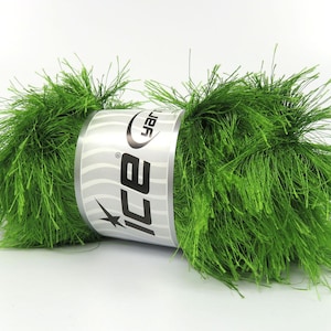 May include: A skein of bright green yarn with a fuzzy, textured appearance. The yarn is wrapped with a silver and white label that reads "ice yarn". The yarn is suitable for knitting and crochet projects.