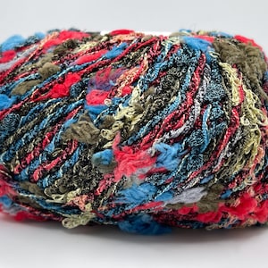 May include: A colorful ball of yarn with a textured, multi-colored design. The yarn features shades of red, blue, green, and brown. This yarn is suitable for various knitting and crochet projects.