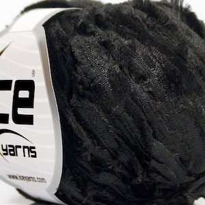 May include: A ball of black fuzzy yarn with a white label that says "Ice Yarns" and has a star on it.