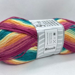 May include: A ball of multi-coloured yarn in shades of pink, orange, yellow, and teal. The yarn is labelled "Biscuit" and is 100% premium micro acrylic. The ball is 100 grams and 350 metres long.