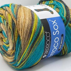 May include: A skein of Berroco Vintage Sock yarn in the colorway "Autumn Leaves". The yarn is a blend of wool, nylon, and silk, and is a sock weight yarn. The yarn is a variegated color, with shades of brown, green, and yellow.