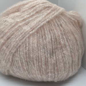 May include: A ball of beige yarn with silver glitter thread woven throughout.