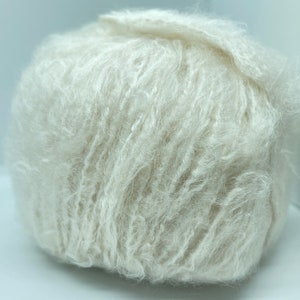 May include: A ball of soft, fluffy, white yarn.