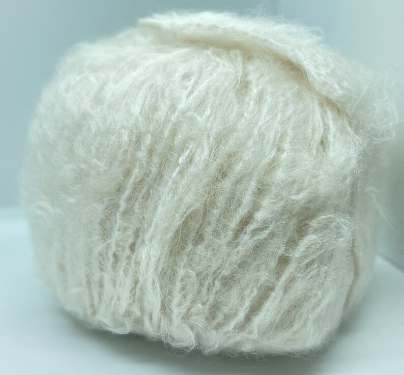 May include: A ball of soft, fluffy, white yarn.