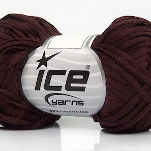 May include: A skein of brown ribbon yarn with a white label that says "ICE yarns" and "www.iceyarns.com".