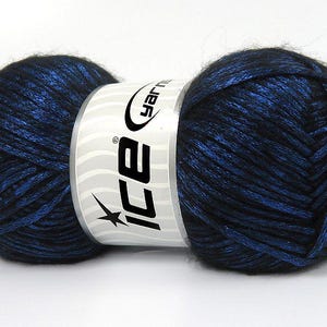 May include: A skein of black and blue yarn with a silver shimmer. The yarn is wrapped around a white label with the text "Ice Yarn" in black.
