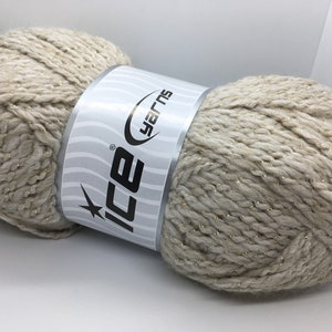 May include: A skein of beige yarn with gold thread running through it. The yarn is labeled "Ice Yarns".