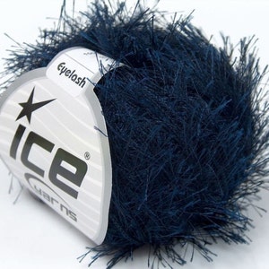 May include: A ball of dark blue eyelash yarn with a white label that says "Ice Yarns" and "Eyelash".