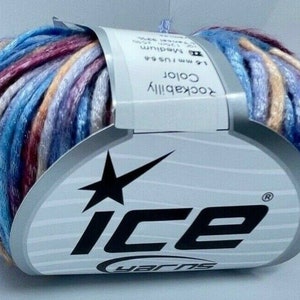 May include: A skein of variegated yarn featuring a blend of blue, purple, red, and beige tones. The yarn is wrapped in a white paper label with the text Ice Yarns, Rockabilly Color, and technical specifications including 4.5-5.5 mm needle size.