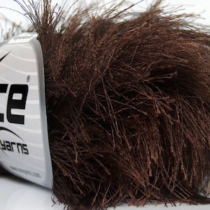 May include: A skein of brown fuzzy yarn with a white label that says "Ice Yarns".