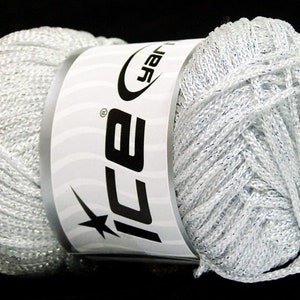 May include: A skein of silver yarn with a white label that says "ICE" in black letters. The yarn has a subtle shimmer.