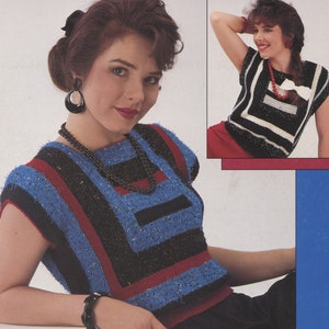 May include: Two women wearing sleeveless tops with geometric patterns in black, white, blue and red. The tops have a loose fit and a scoop neck.