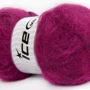 May include: A close-up of a skein of vibrant magenta yarn. The yarn is fluffy and soft, with a slight sheen. The label on the yarn reads "ice" in a stylized font. This yarn is perfect for knitting and crocheting projects.