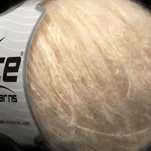 May include: A skein of light beige yarn with a label that reads "Ice Yarns" and "www.iceyarns.com".