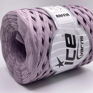 May include: A spool of lavender raffia yarn. The yarn is wrapped in a cylindrical shape, with a label that reads "RAFFIA" and "ICE yarns". The yarn is a light purple color.