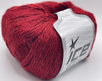 May include: A ball of deep red yarn, tightly wound, with a textured appearance. A silver label with the word "ICE" and a starburst design is wrapped around the yarn. Ideal for knitting and crochet projects.
