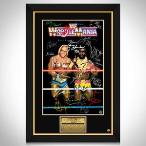 May include: Framed WrestleMania poster featuring Hulk Hogan and Mr. T in a wrestling ring. The poster has multiple signatures and the WrestleMania logo in purple, yellow, and red. The frame is black with a gold inner border.