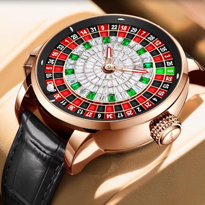 May include: A gold-tone watch with a black leather band. The watch face features a roulette wheel design with diamonds and green gemstones.