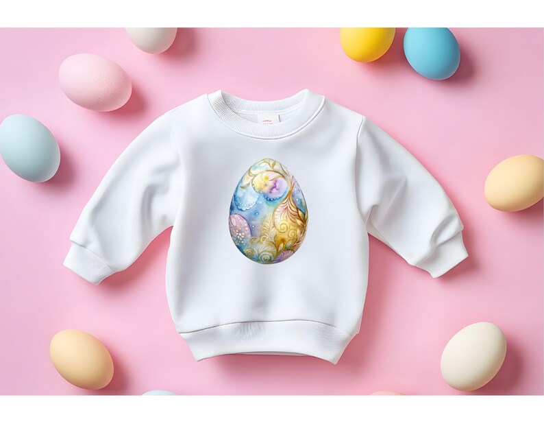May include: White sweatshirt with a colorful, ornate Easter egg design on the front.